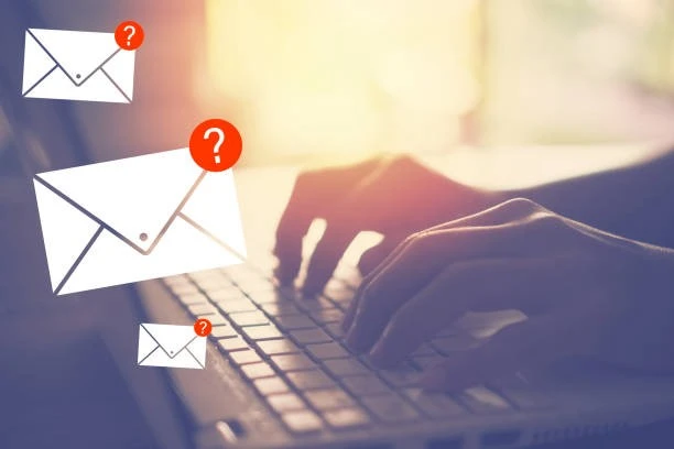 Typing in a keyboard with email icons