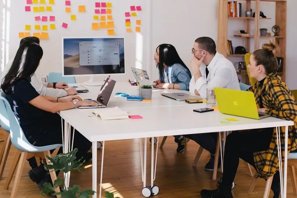 People in a meeting talking about Budget-Friendly Cold Email Tools