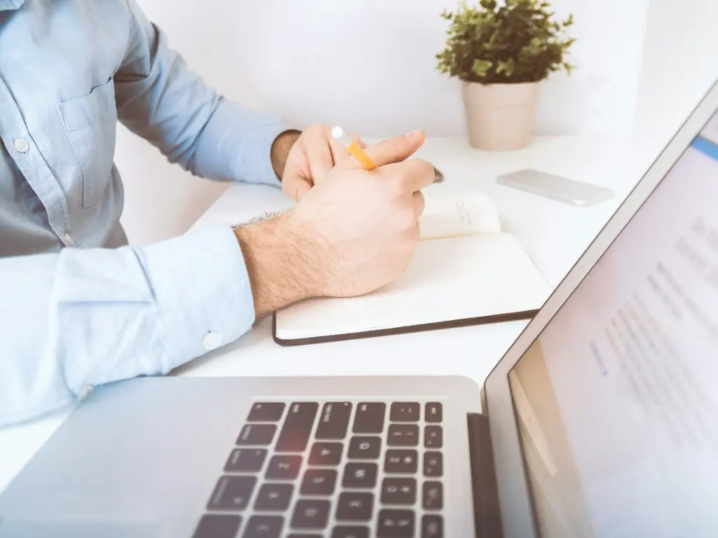 A man taking notes for his email marketing strategy
