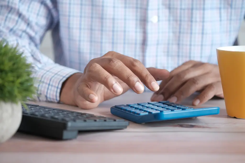 An accountant using his calculator