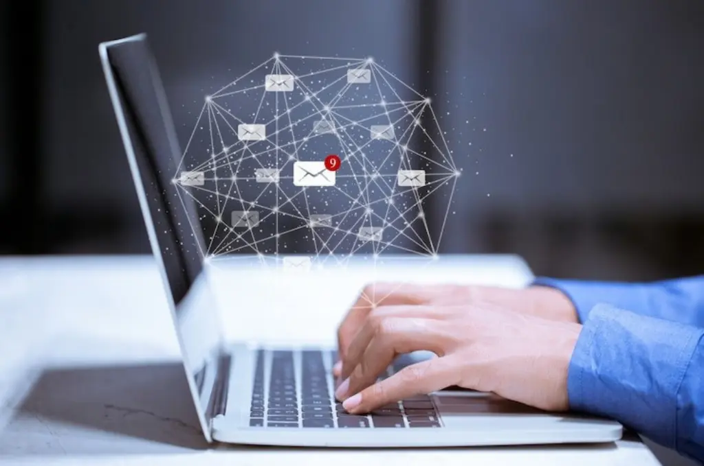 Typing in laptop with email icon