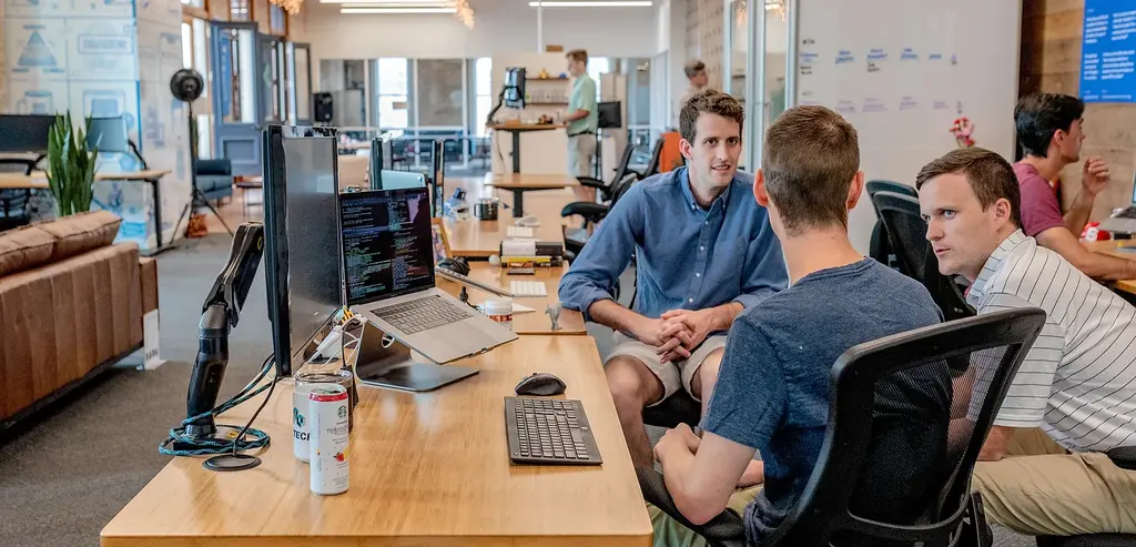 Co-workers discussing in an office.