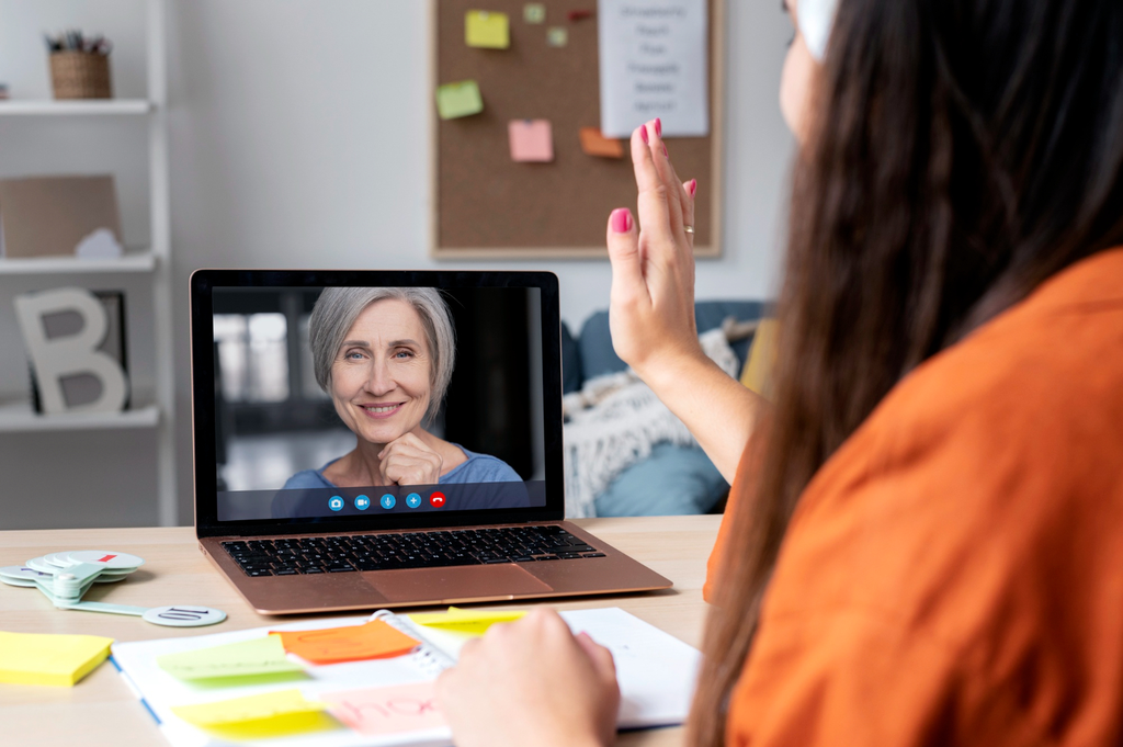 An image of a woman on a laptop screen receiving online coaching