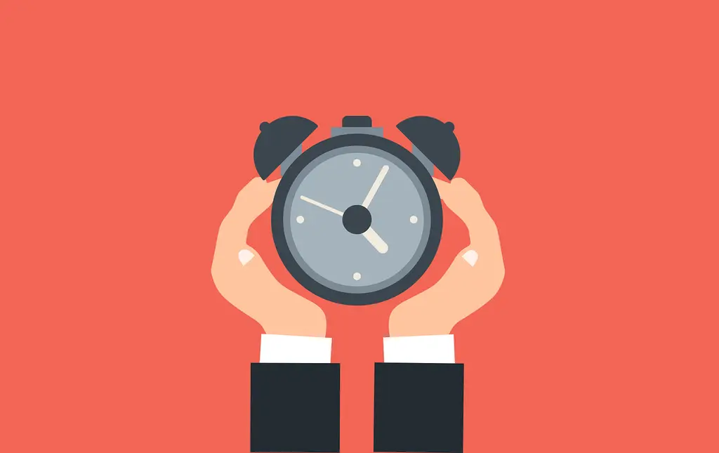 Holding a clock that shows urgency
