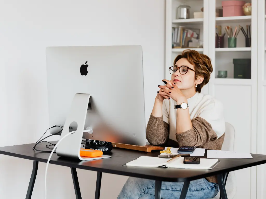 A woman sitting in front of her computer