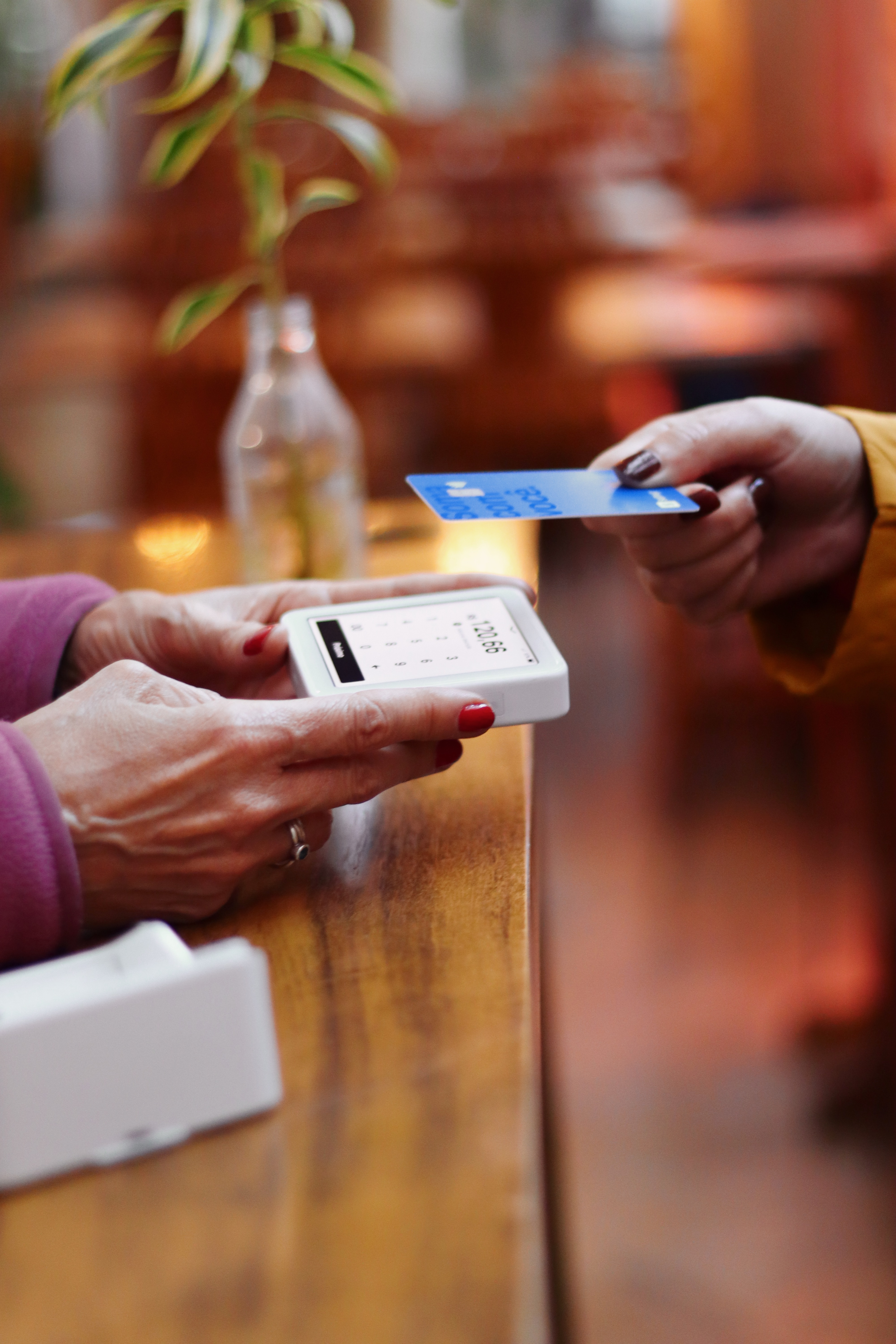 The customer paying her monthly subscription using her card.