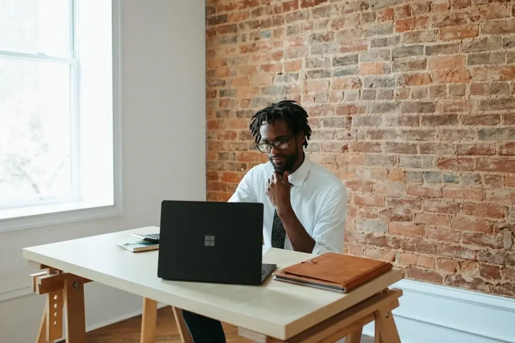 A man working with his desk and laptop