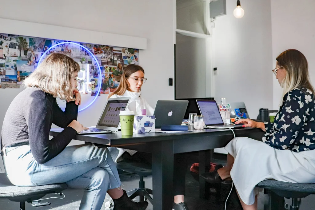 An image of 3 women working on their laptops